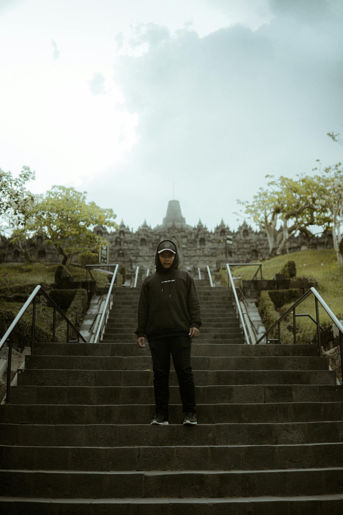 Man standing on steps at an old place in Indonesia
