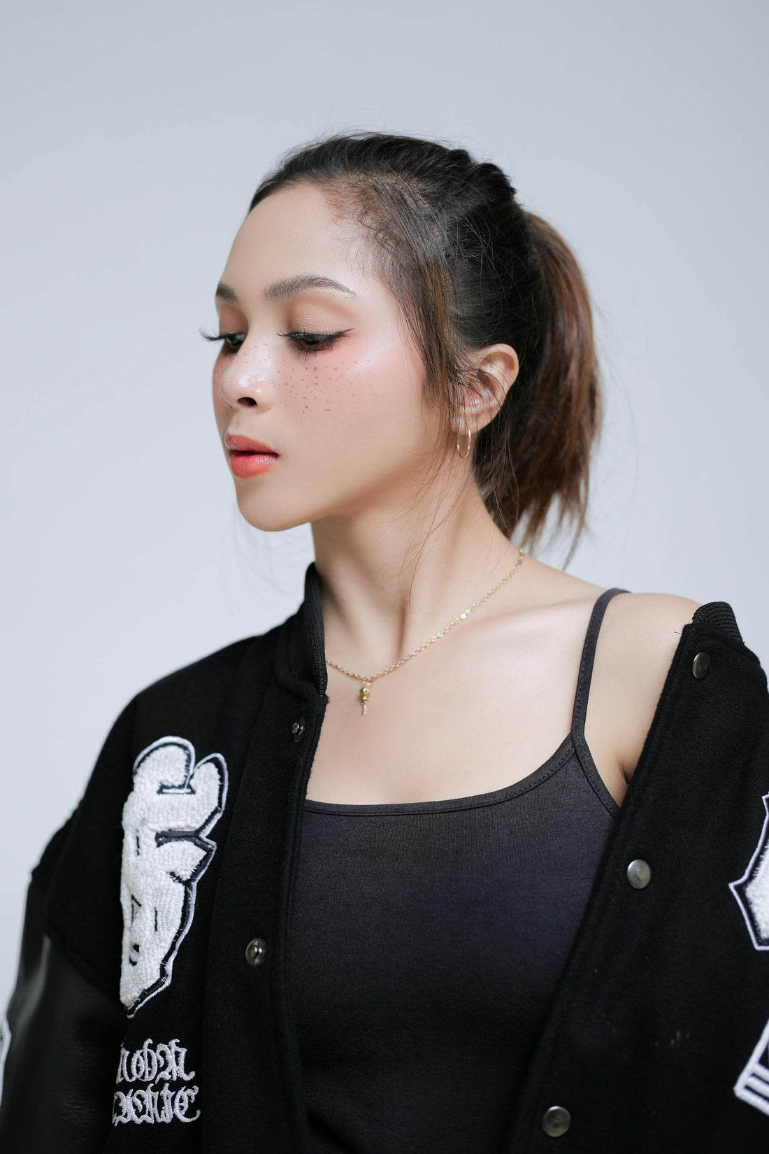 Stylish woman wears black jacket in Indonesia