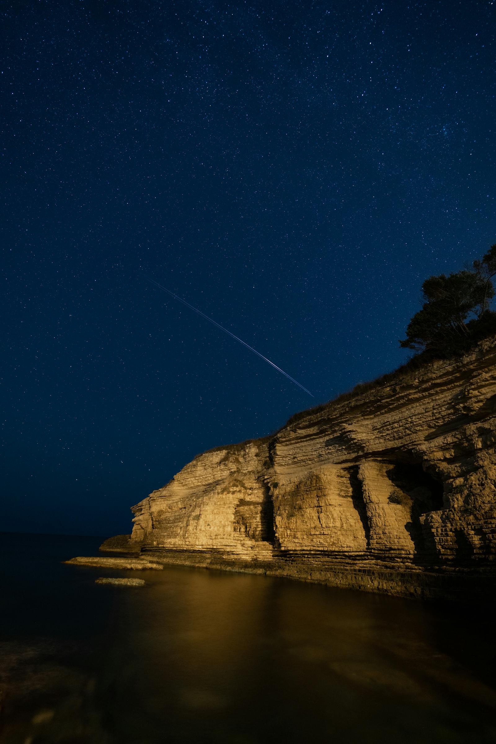 Shooting stars over water at night