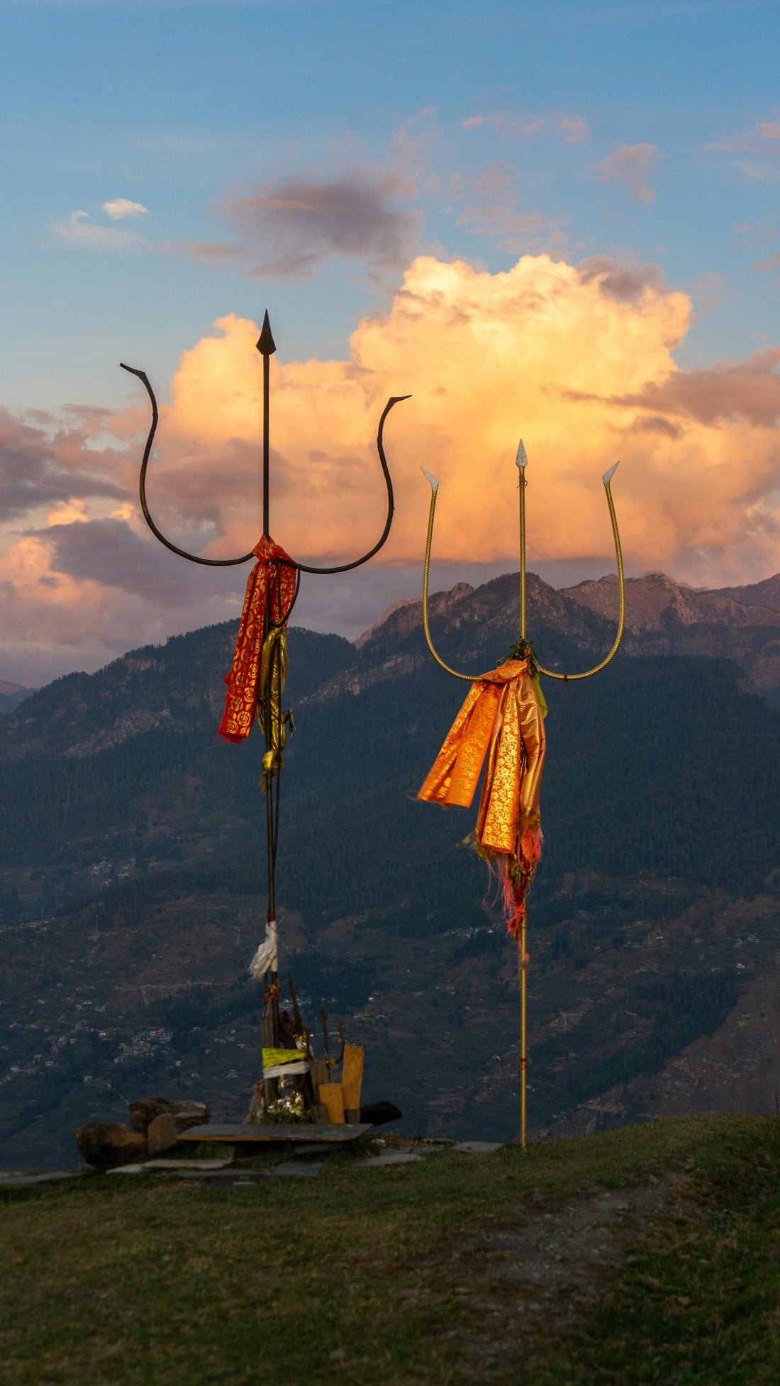 Vibrant Sunset Behind Sacred Tridents in Bijli Mahadev Himachal Pradesh