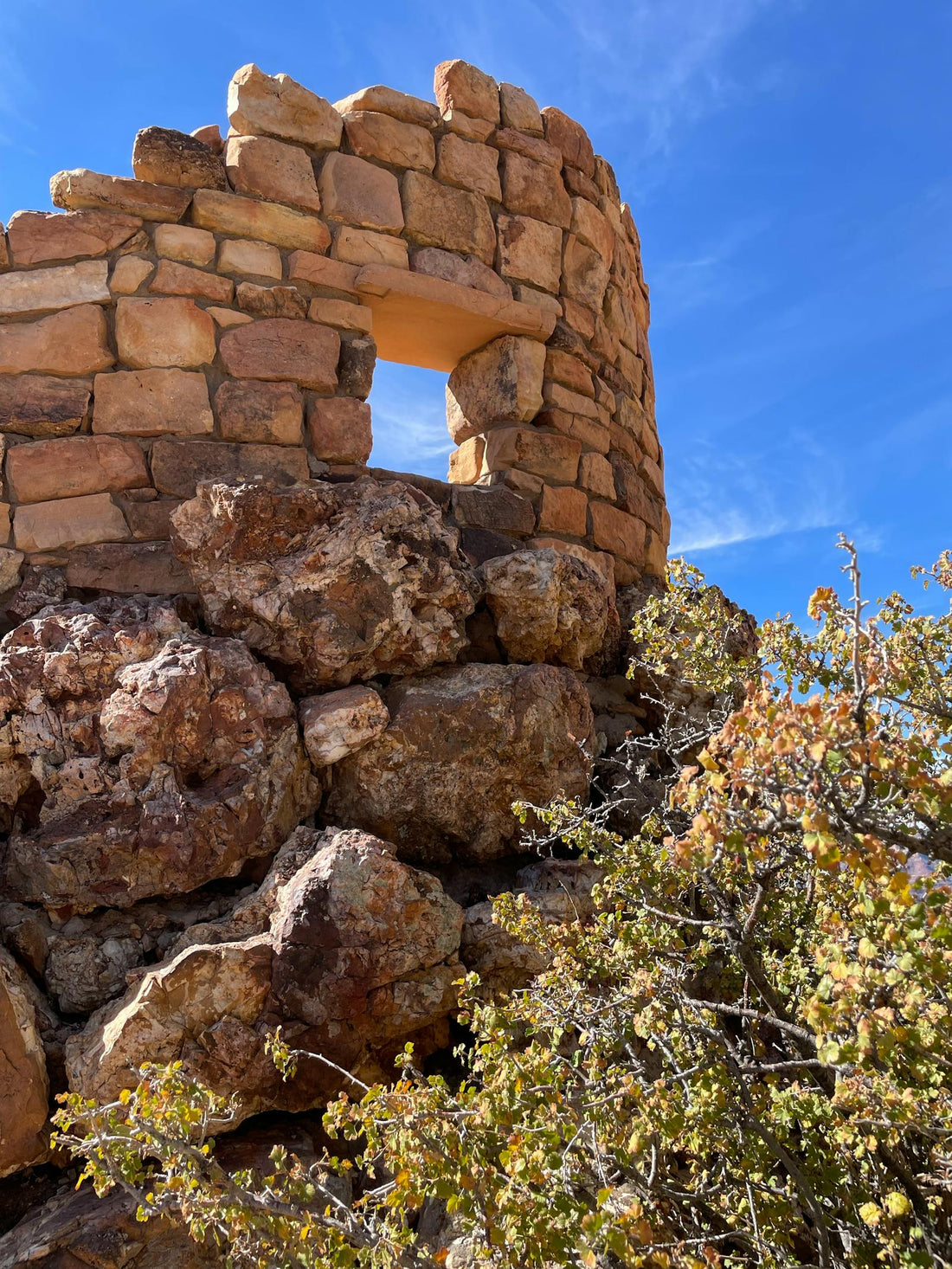 Weathered Stone Tower Against a Vibrant Blue Sky