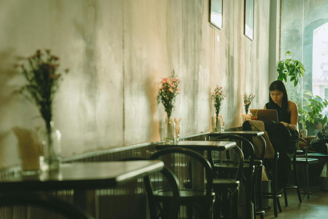 Woman working on laptop in cozy cafe in Ho Chi Minh City