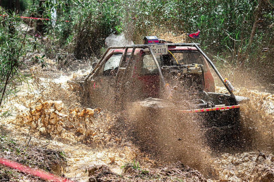 Driving a Vehicle Through Muddy Water in Cambodian Wilderness