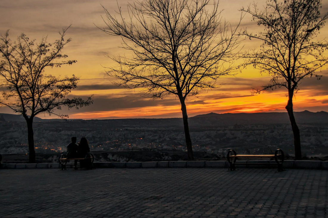 A Couple Enjoying a Sunset View From a Peaceful Hilltop