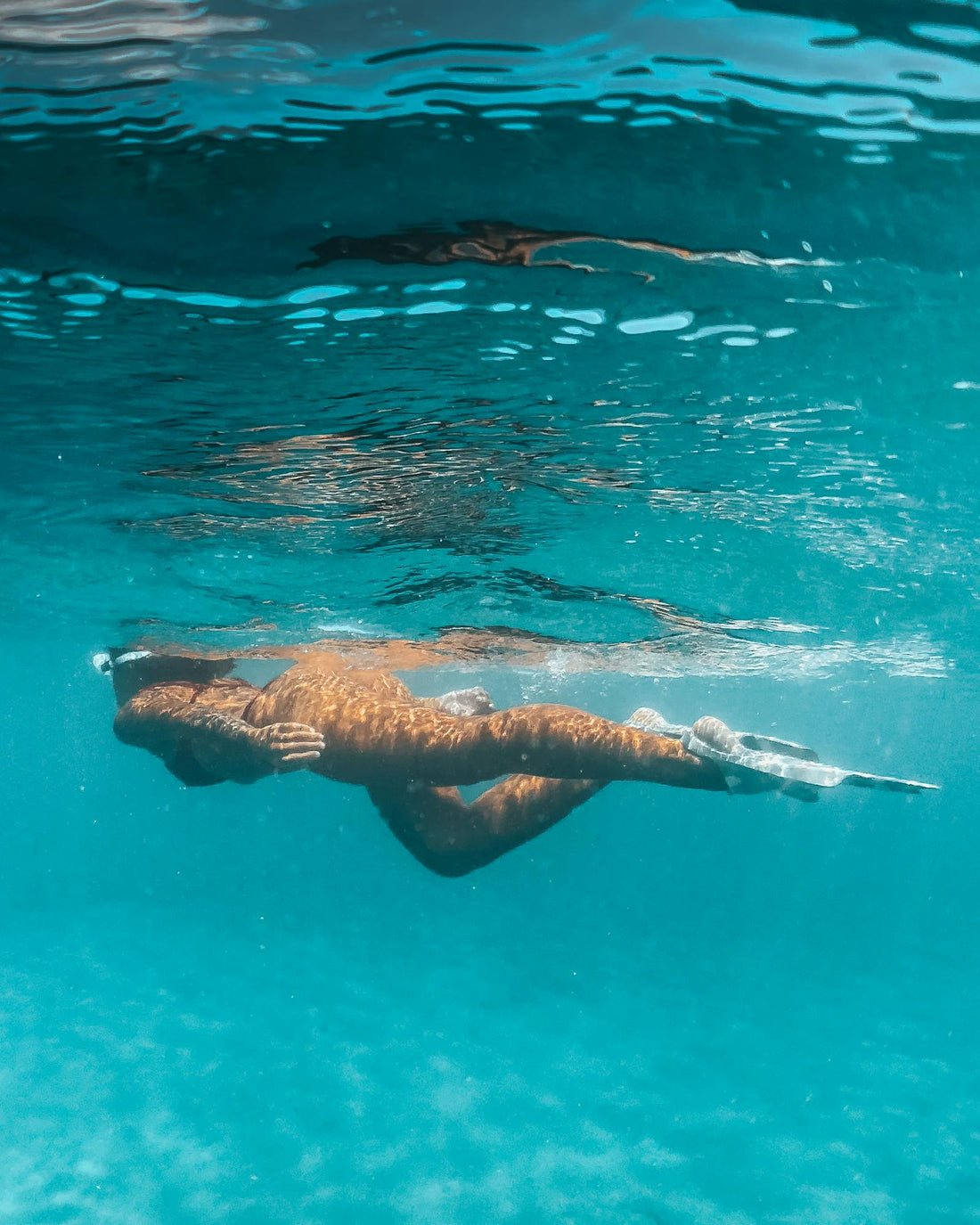 Snorkeling in clear blue ocean water