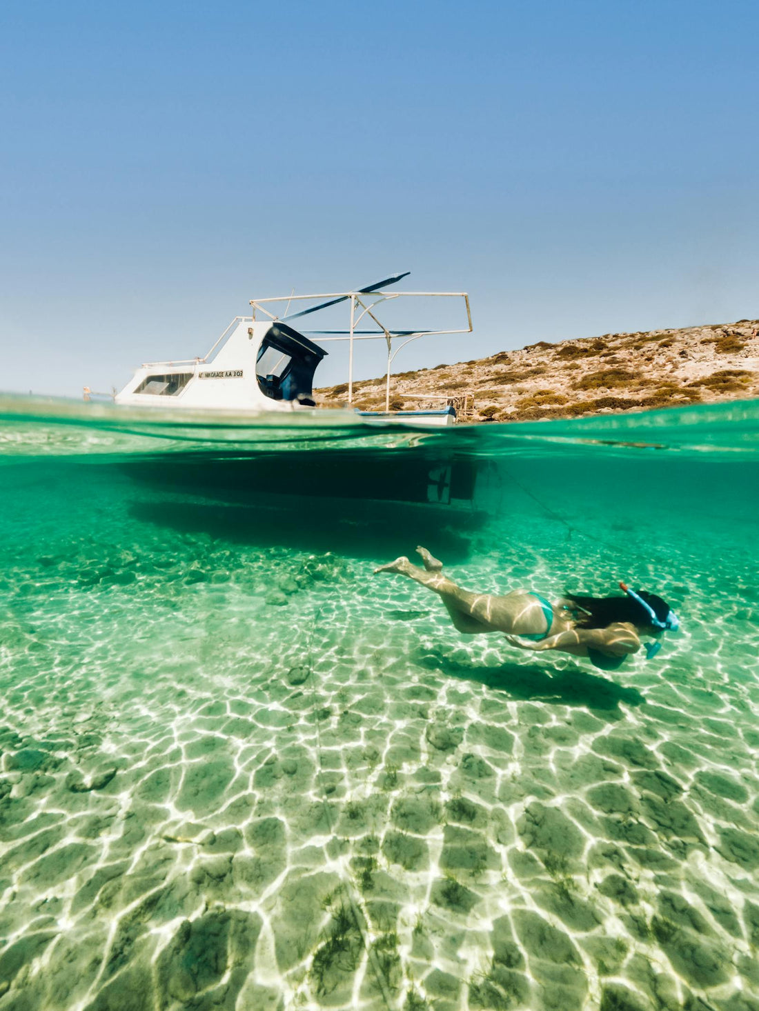 Explore underwater in Greece near a boat